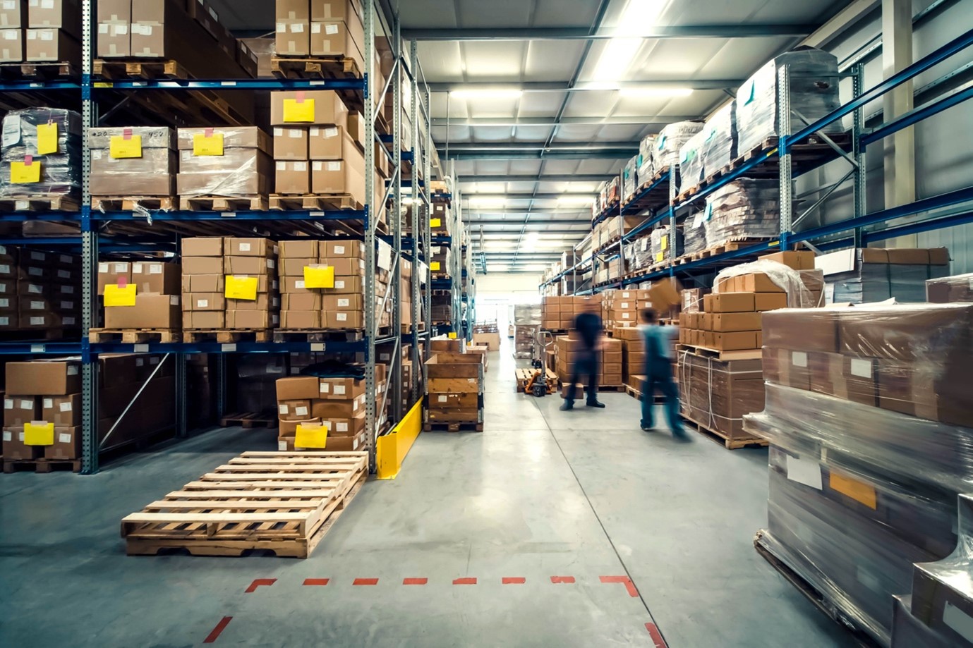 A warehouse with many boxes and pallets