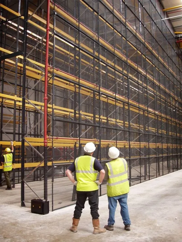 Warehouse racking inspection showing damaged upright and safety concerns in storage system